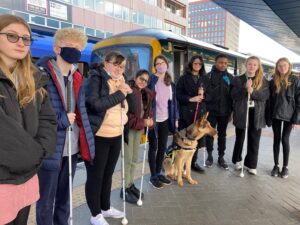 Berkshire Visoion teen members stood on a platform in front of a train