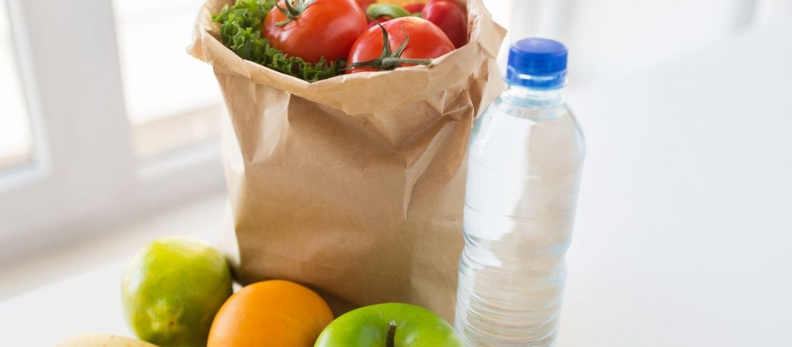 A bag f fruit and a bottle of water