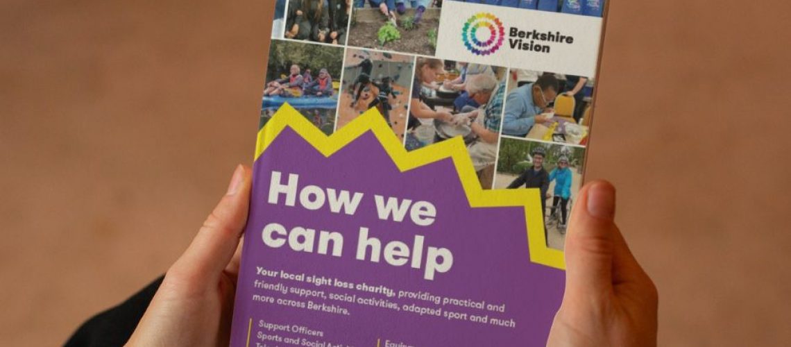 Hands can be seen holding the how we can help brochure