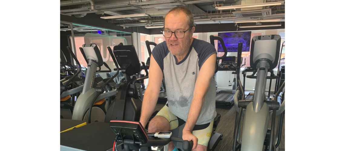 Andy is on an exercise bike in the gym